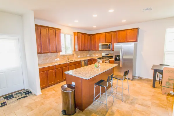a kitchen with a sink stove and refrigerator
