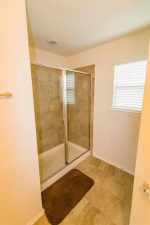 a bathroom with a granite countertop sink mirror vanity and toilet