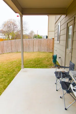 a view of a patio with a table chairs and a lake view