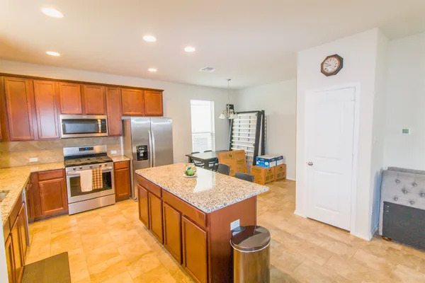 a kitchen with a stove sink and a refrigerator