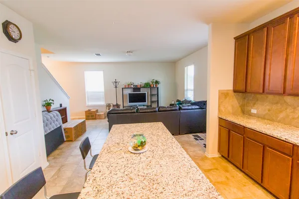 a large kitchen with sink a counter top space and stainless steel appliances