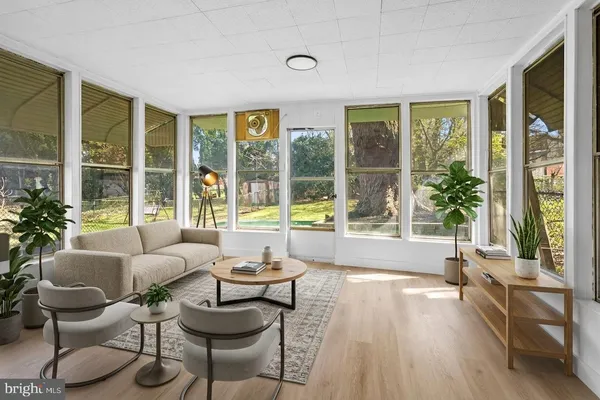 a view of room with window and wooden floor