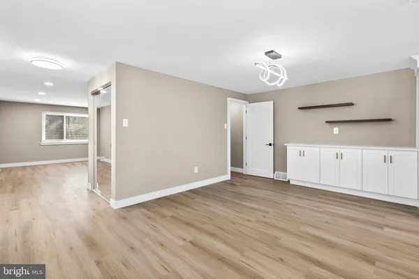 a kitchen with stainless steel appliances kitchen island granite countertop a table chairs stove and refrigerator