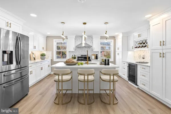 a kitchen with stainless steel appliances granite countertop a white cabinets and a refrigerator
