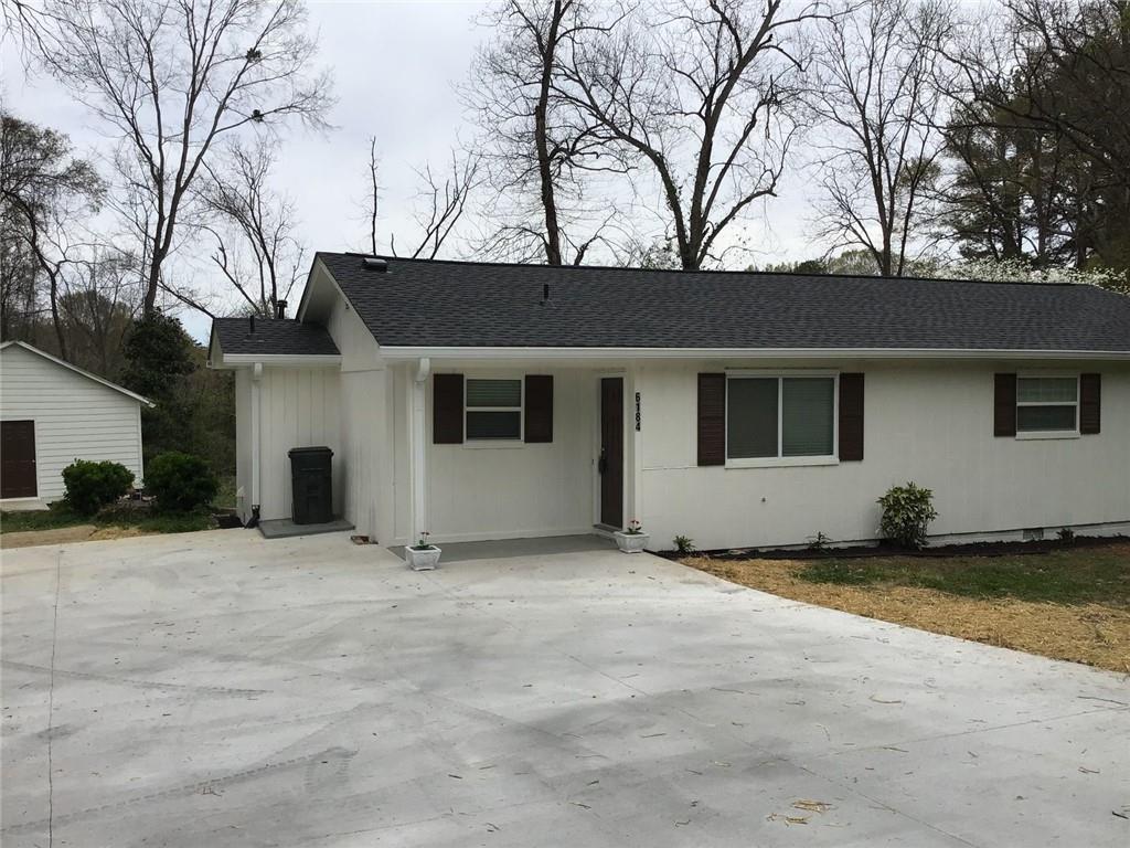 6184 Geiger Street Northwest Covington, GA 30014 - Photo 1 of 16 a view of a house with a yard covered with snow in the house