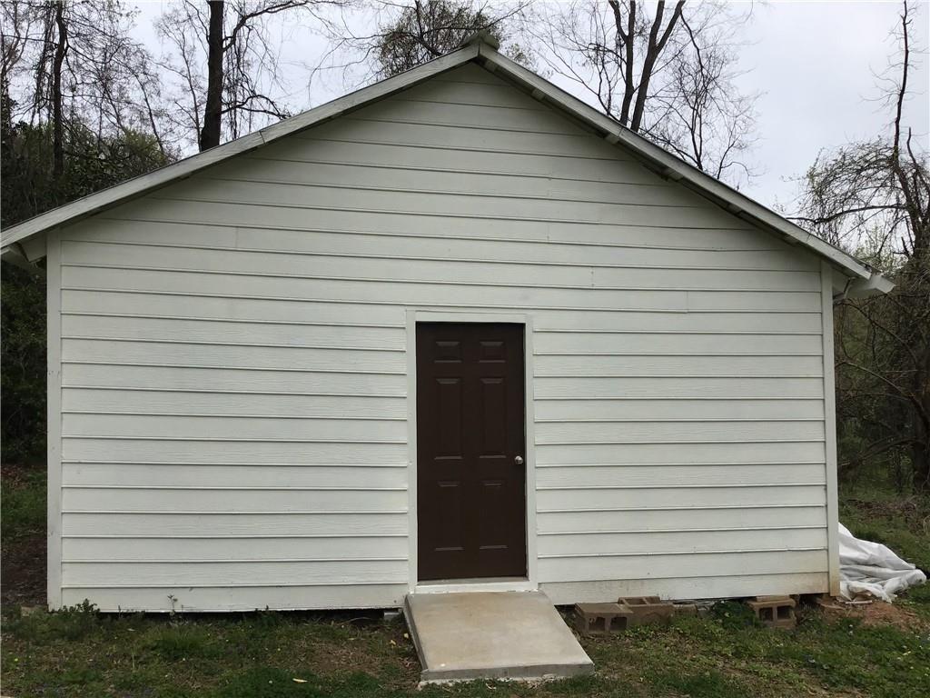 6184 Geiger Street Northwest Covington, GA 30014 - Photo 16 of 16 a small white building with a white roof and stairs