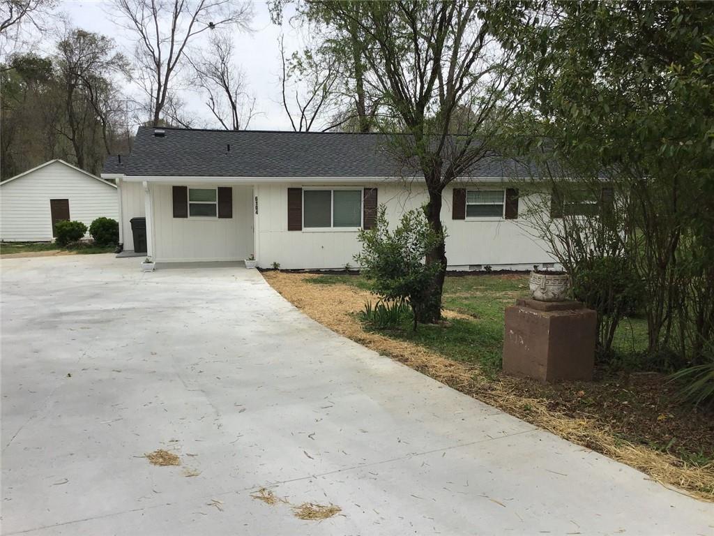 6184 Geiger Street Northwest Covington, GA 30014 - Photo 2 of 16 a front view of a house with a garden