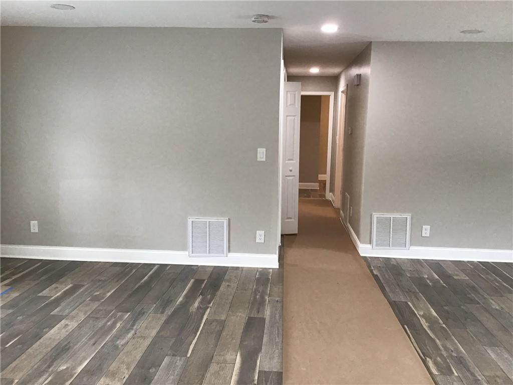 6184 Geiger Street Northwest Covington, GA 30014 - Photo 10 of 16 a view of a hallway with wooden floor