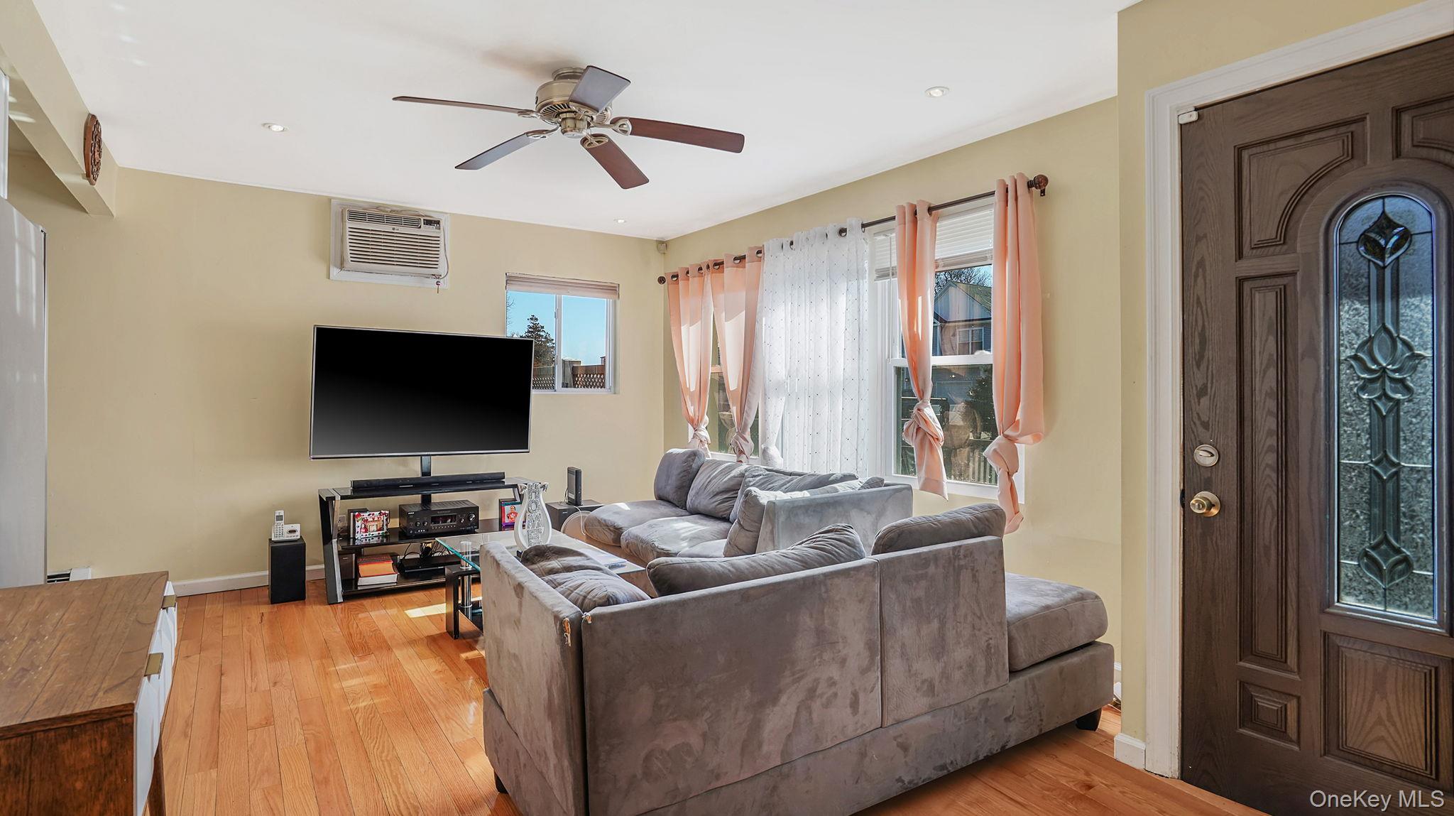 22 North Somerset Road Amityville, NY 11701 - Photo 11 of 25 a living room with furniture and a flat screen tv