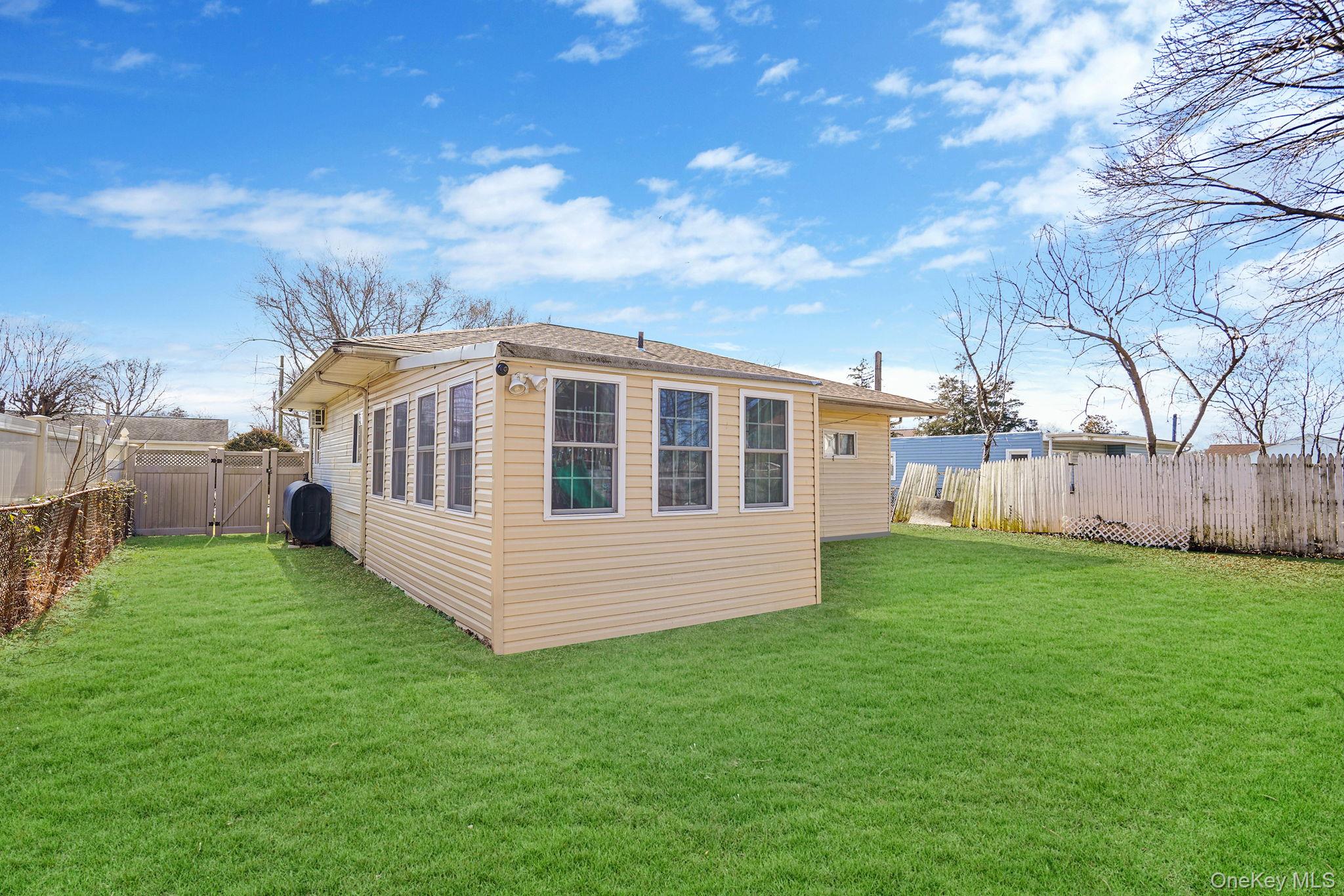 22 North Somerset Road Amityville, NY 11701 - Photo 8 of 25 a view of a house with backyard and garden