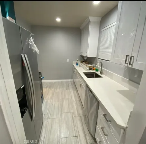 a bathroom with a sink a mirror a vanity and a shower