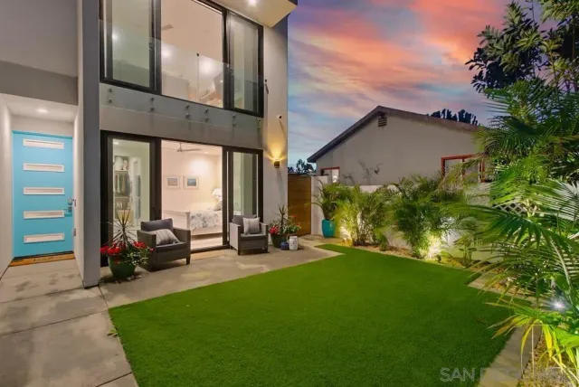 a view of a patio with table and chairs and potted plants