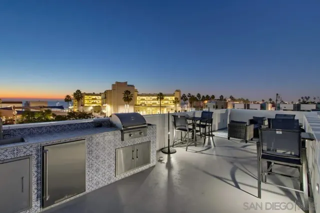 a view of a terrace with outdoor seating and city view