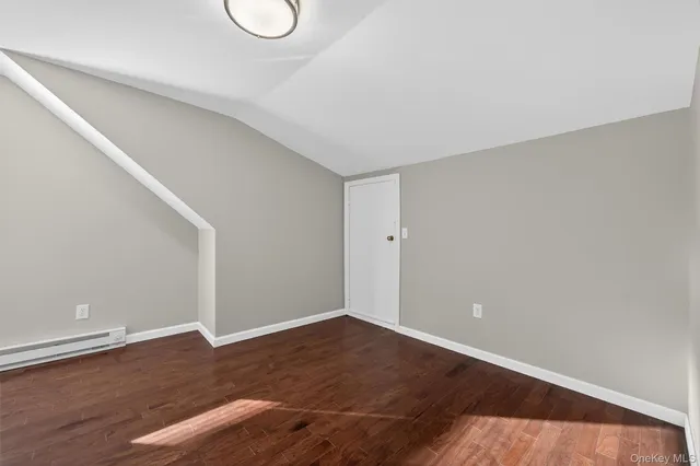 a view of a room with wooden floor and white walls