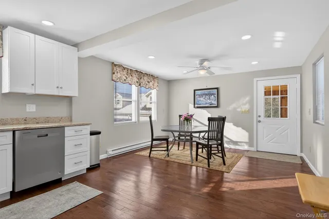 a view of a livingroom with furniture wooden floor and a window