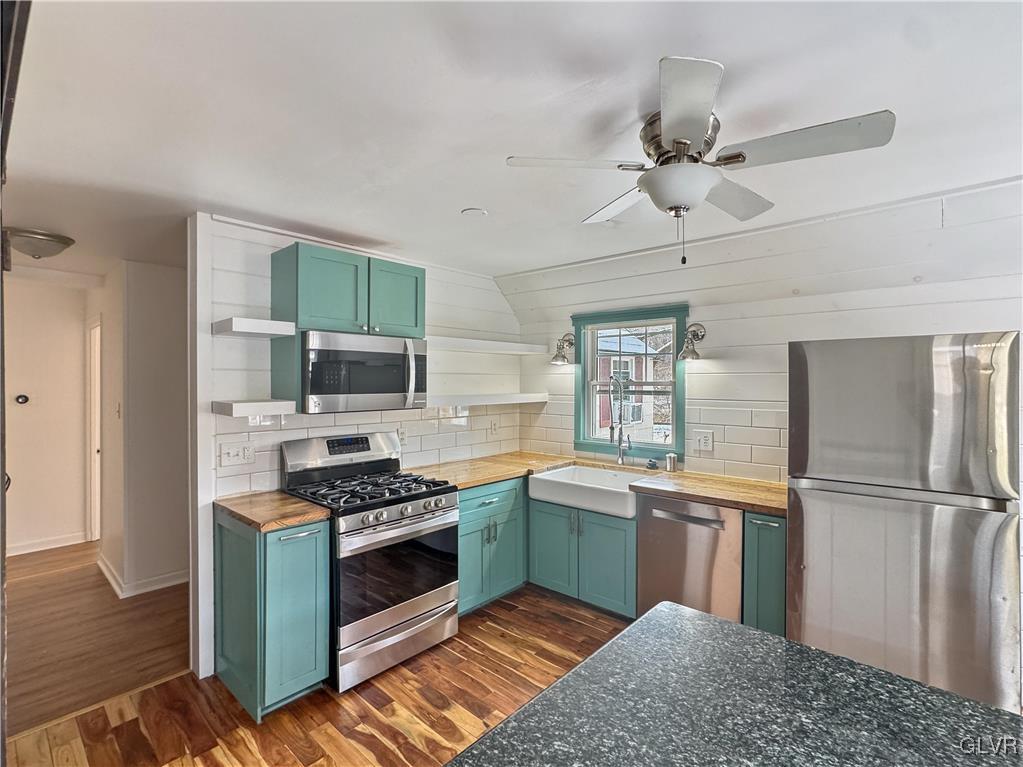 3213 Center Street Bethlehem, PA 18017 - Photo 13 of 38 a kitchen with stainless steel appliances granite countertop a sink a stove and refrigerator