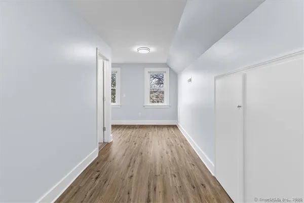 a view of hallway with wooden floor