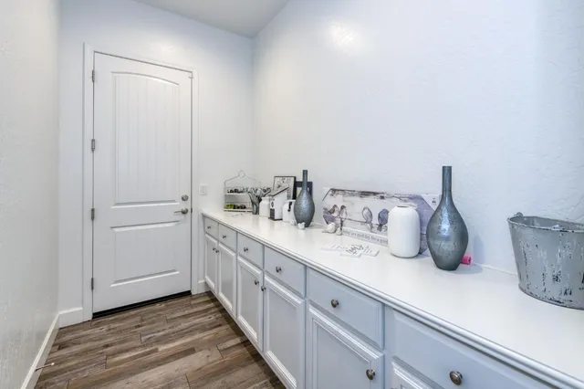 a kitchen with cabinets and window
