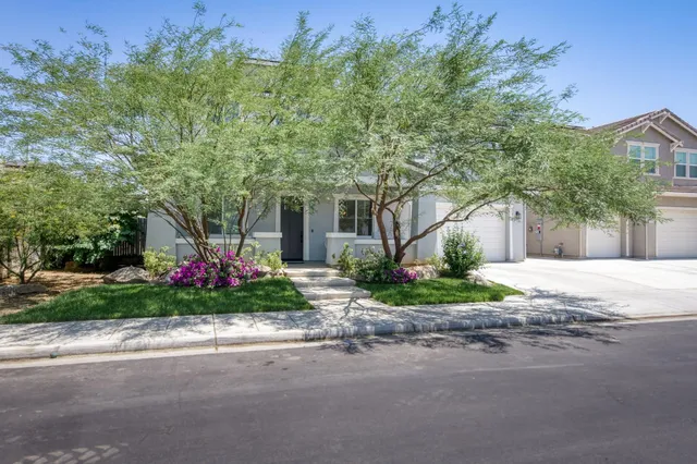 a front view of a house with a yard and a garage