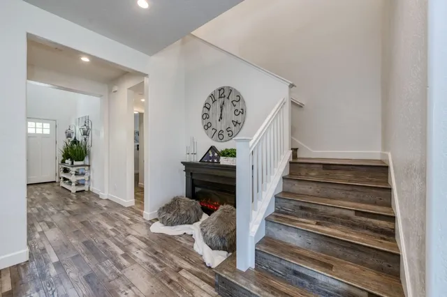 a view of entryway and hall with wooden floor