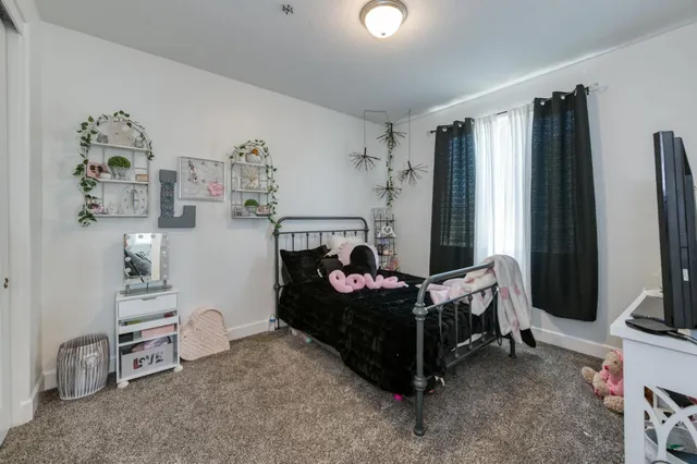 a bedroom with furniture and a flat screen tv