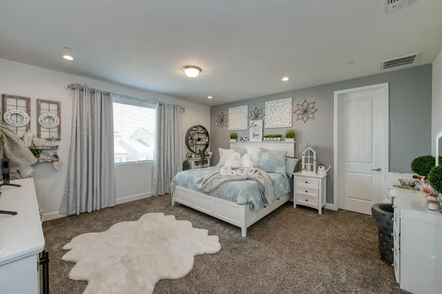 a bedroom with a bed and a window