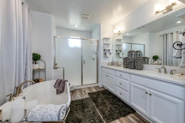 a spacious bathroom with a double vanity sink and a mirror