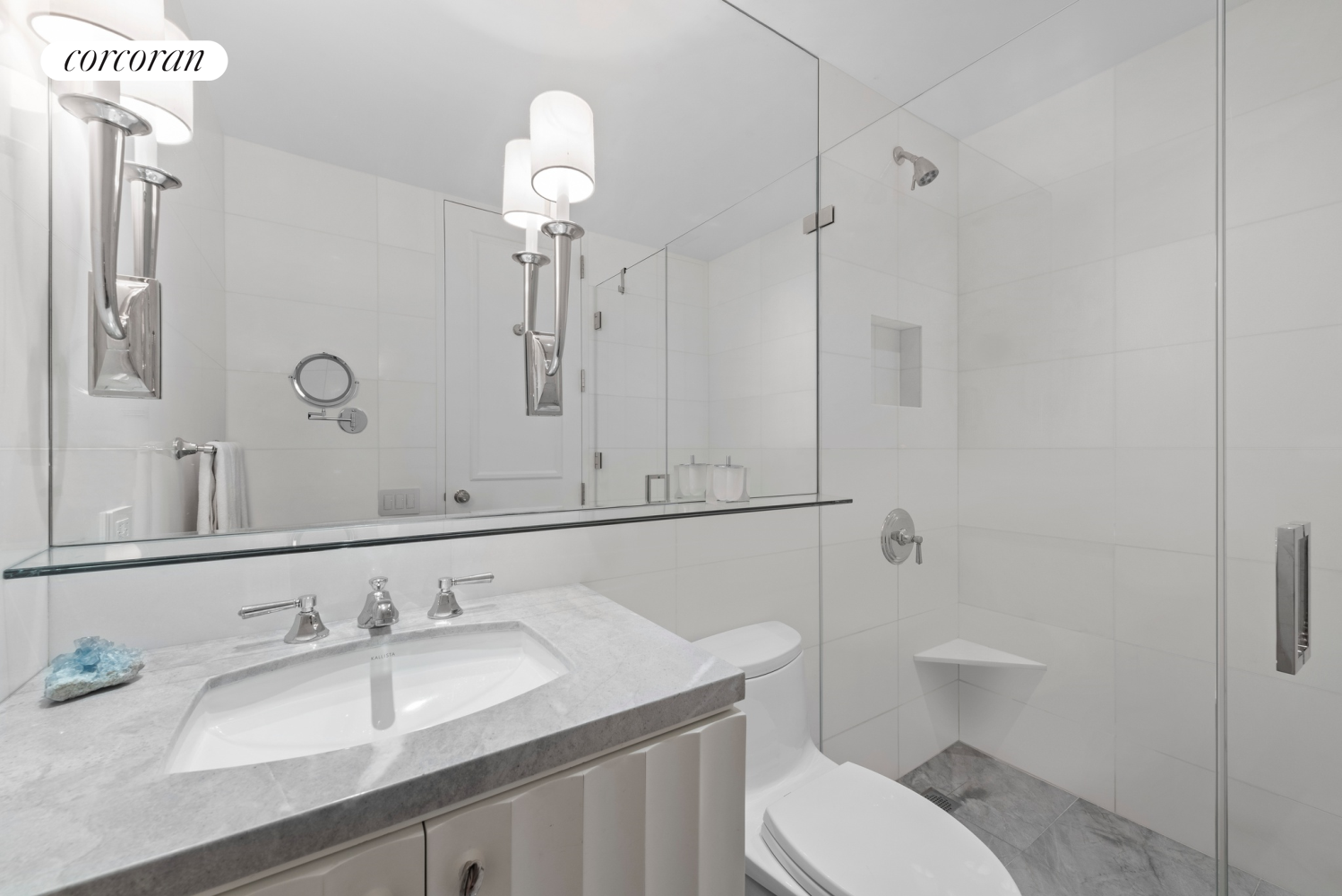 641 5th Avenue, Unit 32D Manhattan, NY 10035 - Photo 10 of 15 a bathroom with a granite countertop sink mirror and toilet