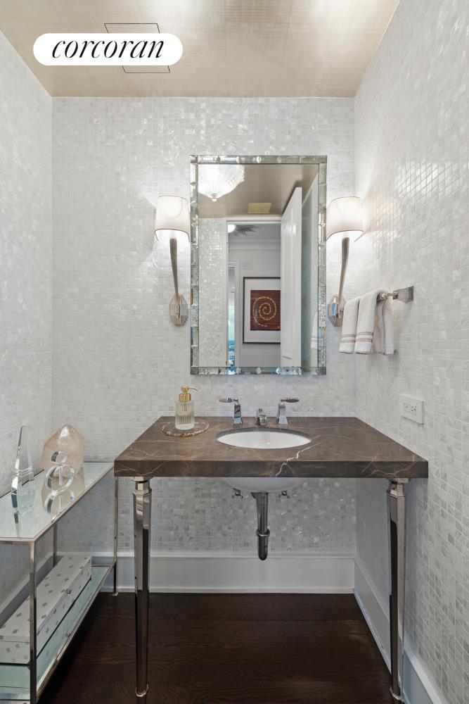 641 5th Avenue, Unit 32D Manhattan, NY 10035 - Photo 14 of 15 a bathroom with a sink and a mirror