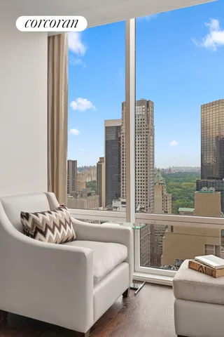 a living room with furniture and a floor to ceiling window