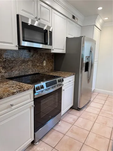 a kitchen with granite countertop a sink and cabinets