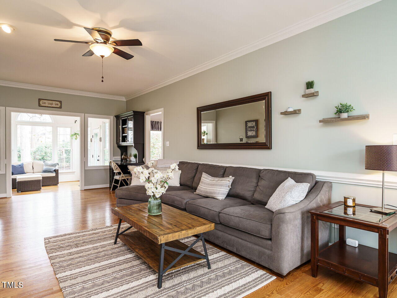 220 Custer Trail Cary, NC 27513 - Photo 11 of 31 a living room with furniture a ceiling fan and a rug