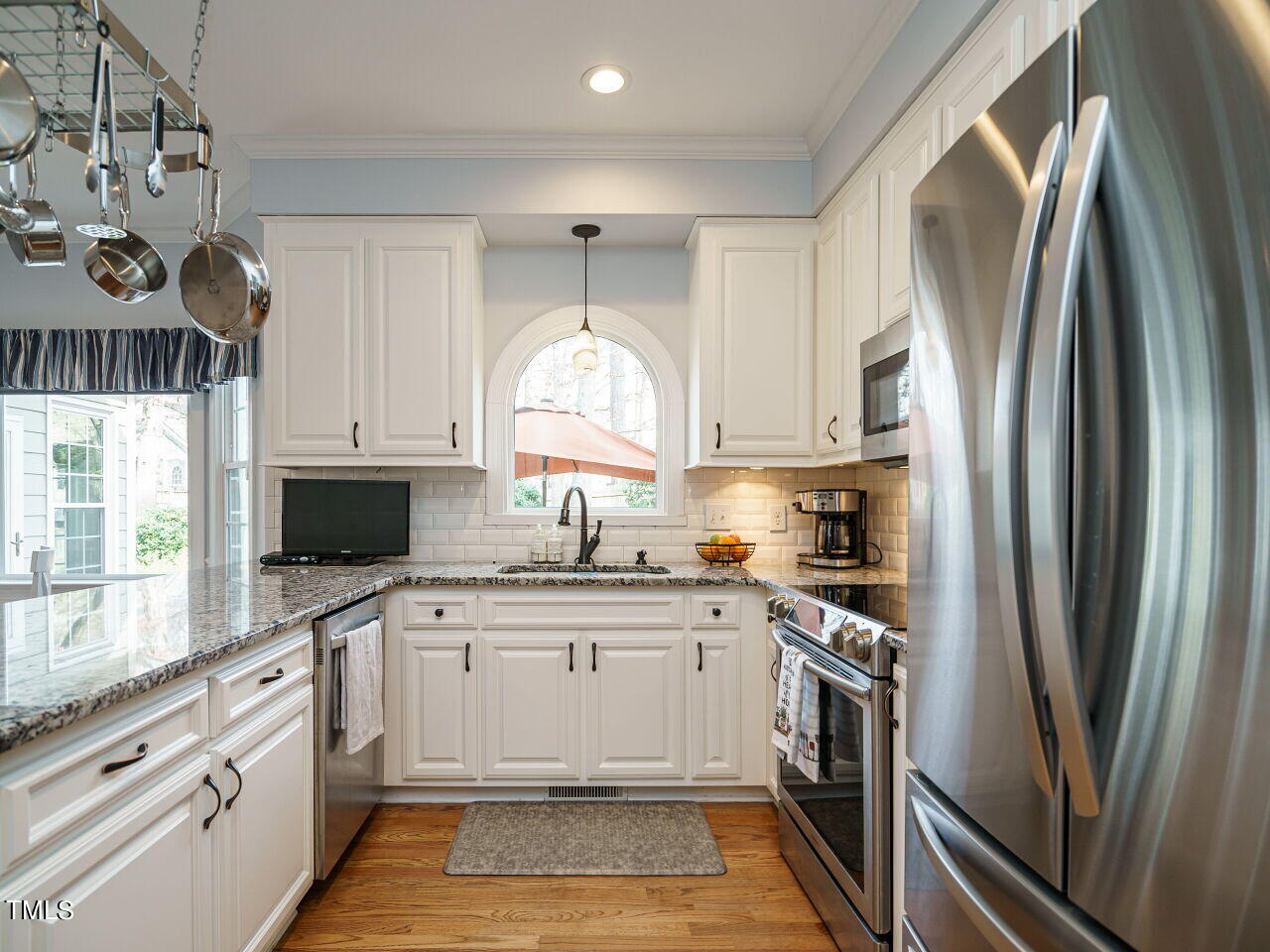 220 Custer Trail Cary, NC 27513 - Photo 13 of 31 a kitchen with a sink a refrigerator and a stove