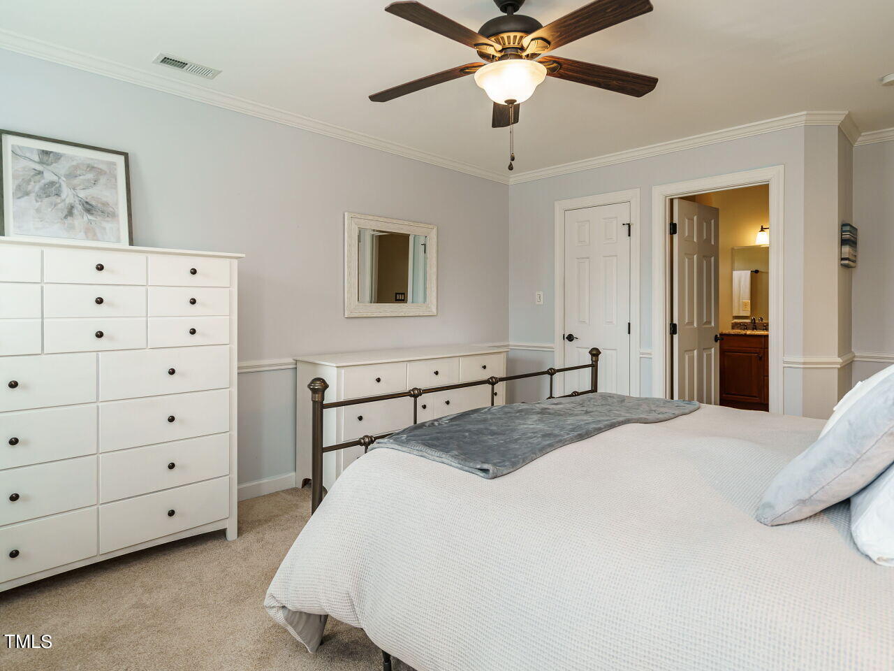 220 Custer Trail Cary, NC 27513 - Photo 16 of 31 a bedroom with a bed and a chandelier