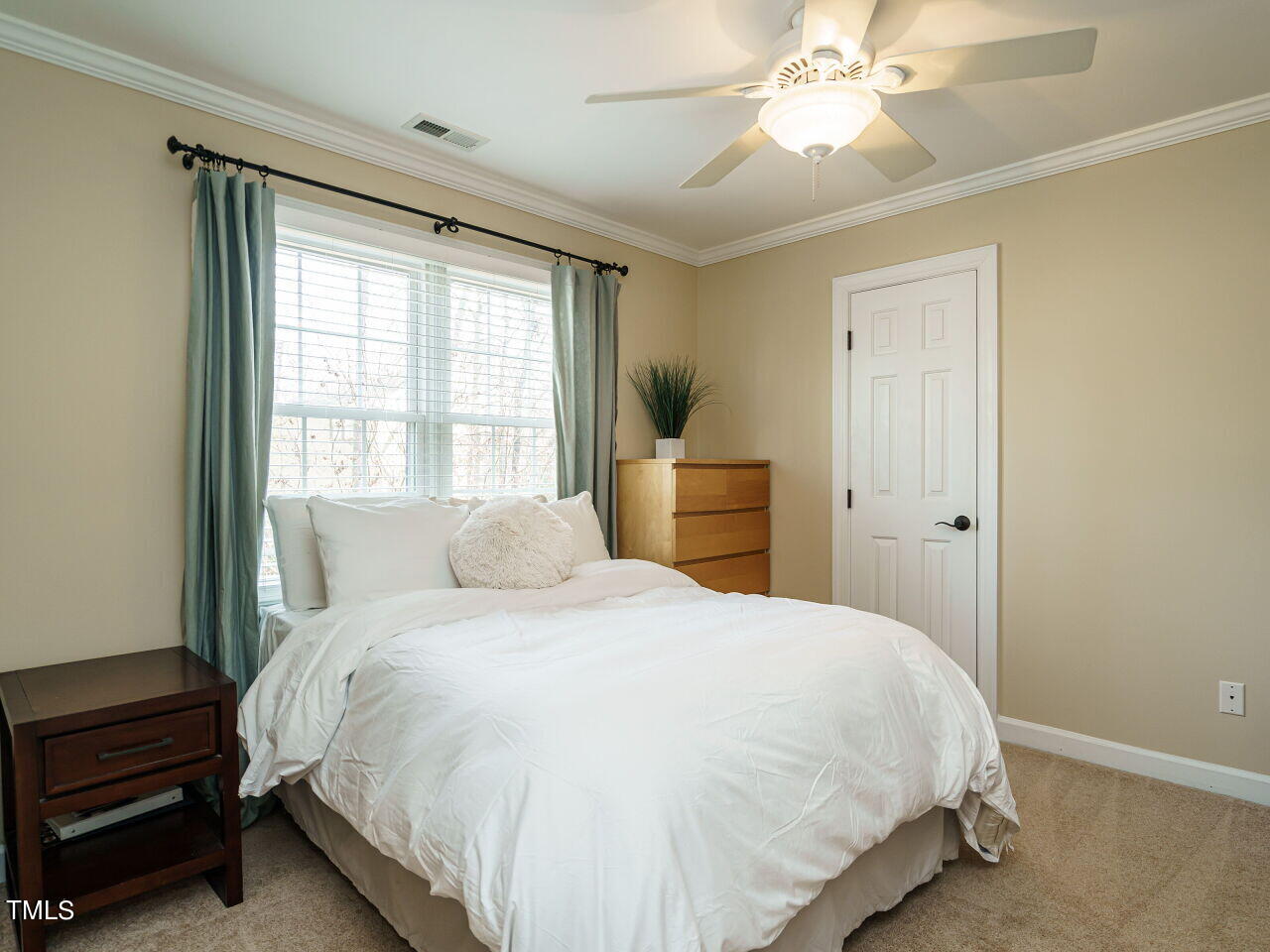 220 Custer Trail Cary, NC 27513 - Photo 23 of 31 a bedroom with a bed and a chandelier