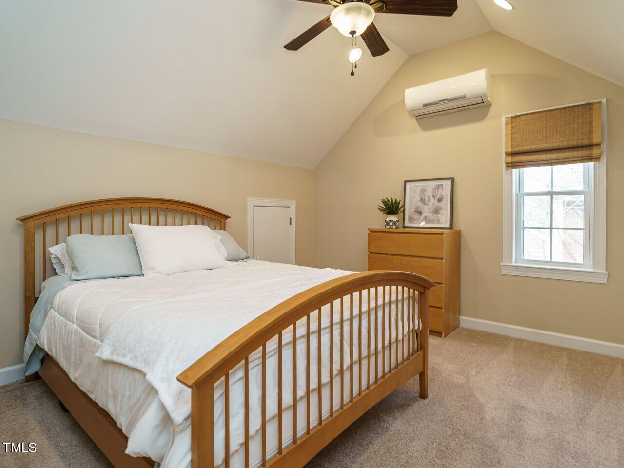 220 Custer Trail Cary, NC 27513 - Photo 25 of 31 a bedroom with a bed and a chandelier