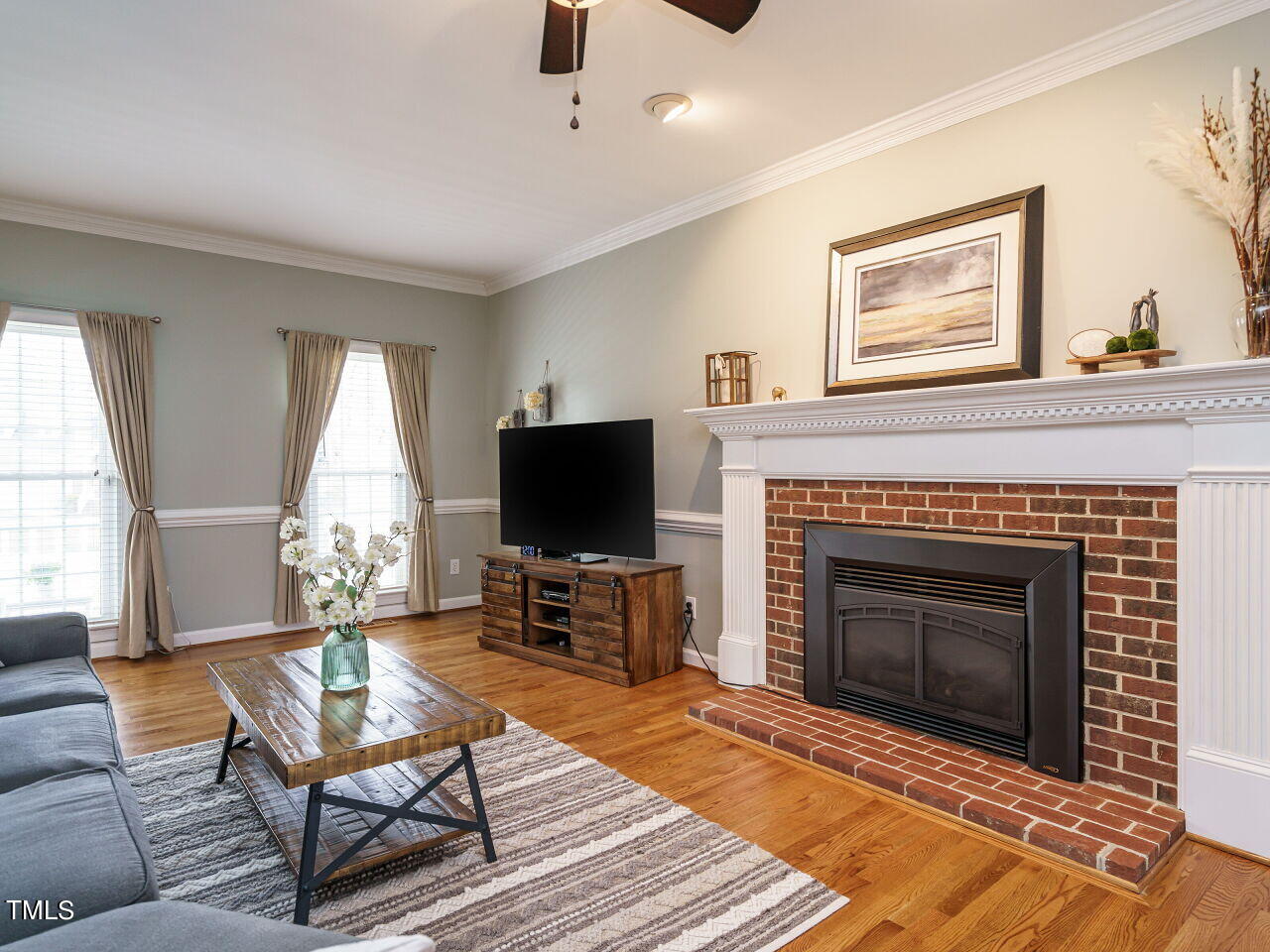 220 Custer Trail Cary, NC 27513 - Photo 10 of 31 a living room with furniture a flat screen tv and a fireplace