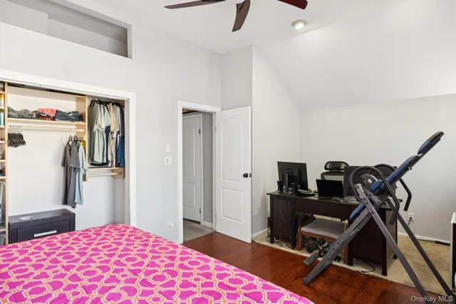 a bedroom with a bed and a wooden floor