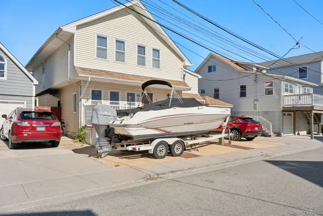 a car parked in front of white house