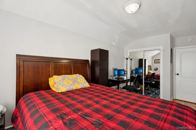 a bedroom with a bed and walk in closet