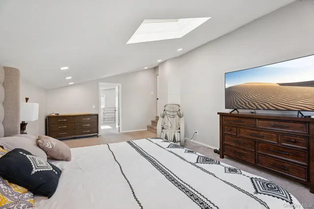 a bedroom with a bed and a television