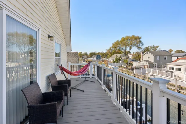 a view of a balcony with two chairs and a potted plant