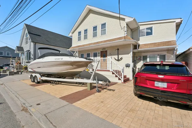 a view of a white house with a sink and wooden floor