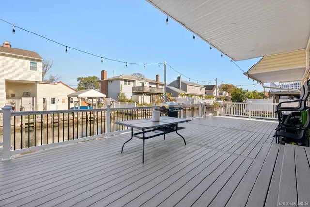 a view of a balcony with chairs and wooden floor