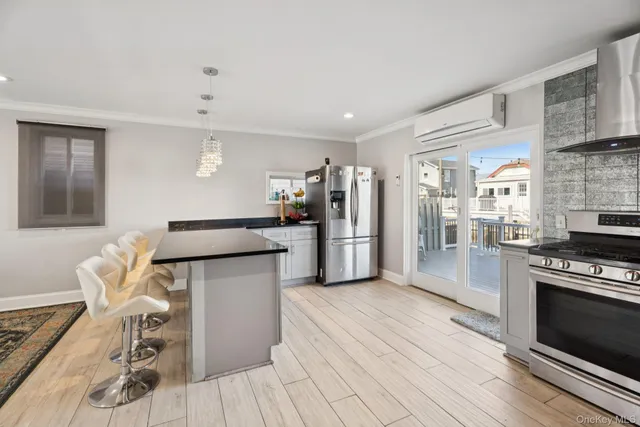 a kitchen with stainless steel appliances a stove a refrigerator and cabinets