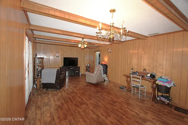 a very nice looking room with wooden floor and furniture