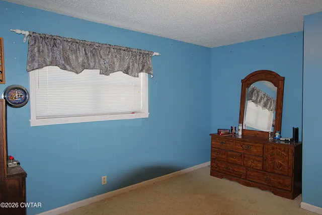 a view of a closet with wooden floor