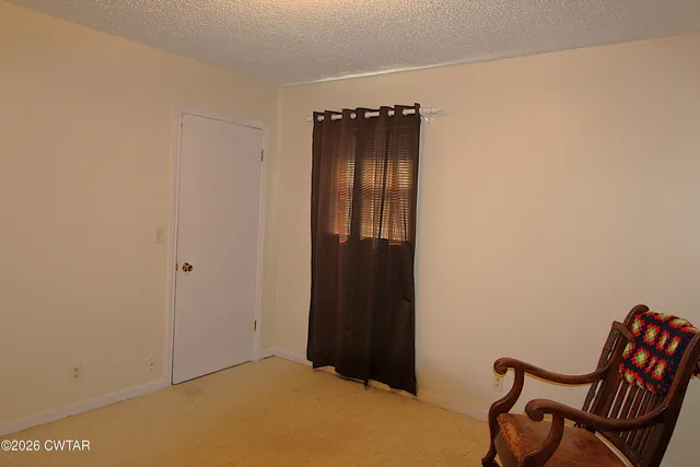 a bed sitting in a room next to a window