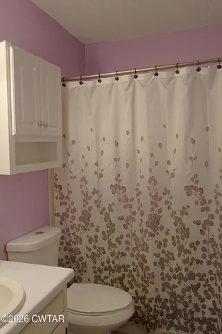 a living room with furniture a window and a piano