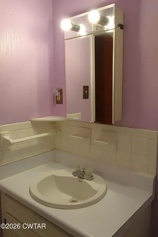 a reading room with furniture and a large window